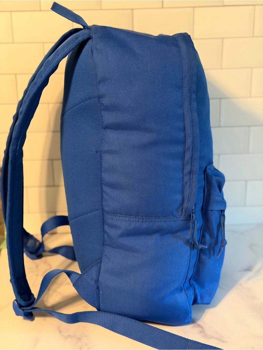 Converse All Star backpack in blue with classic Chuck Taylor logo patch.